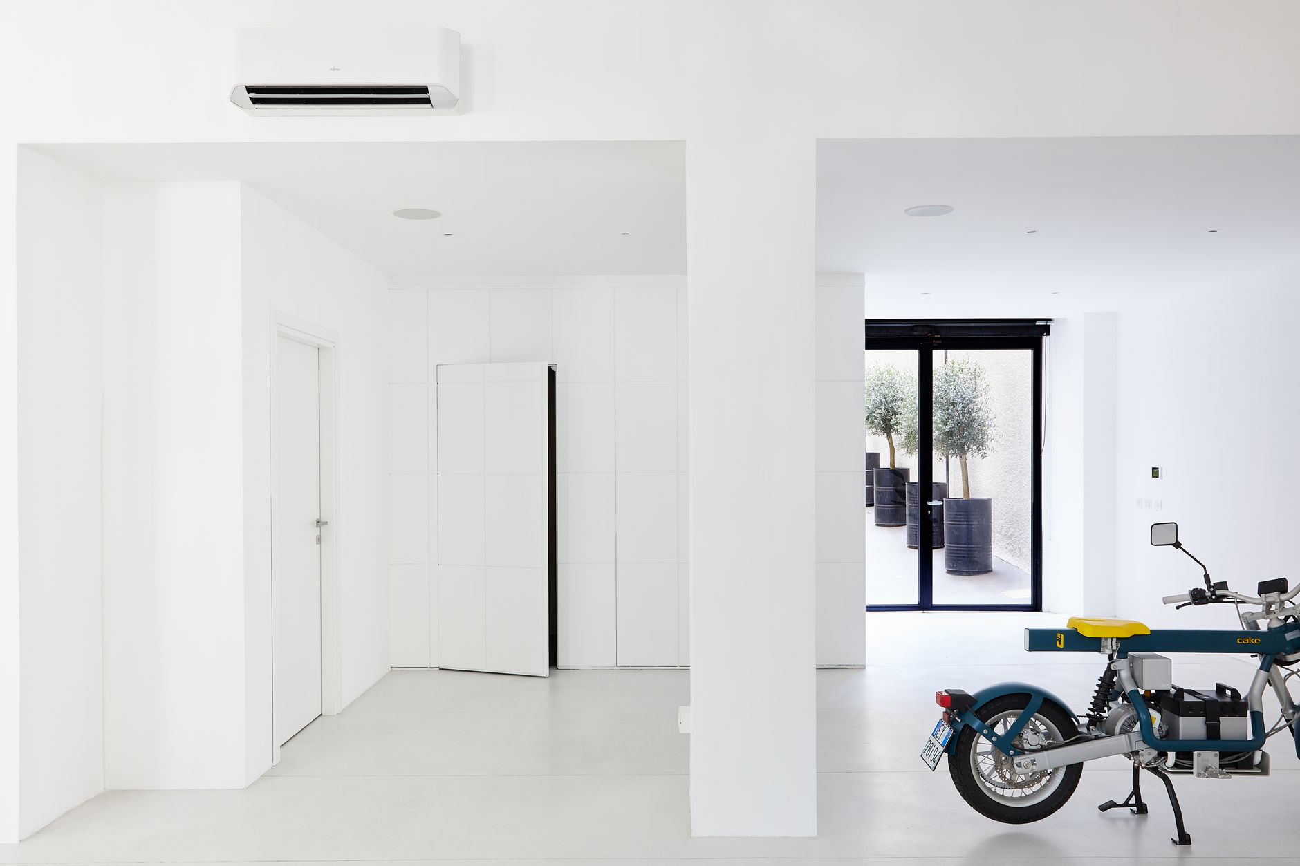 pexels photo 20313909 20313909 Bright minimalist room featuring a modern motorbike and stylish decor elements.